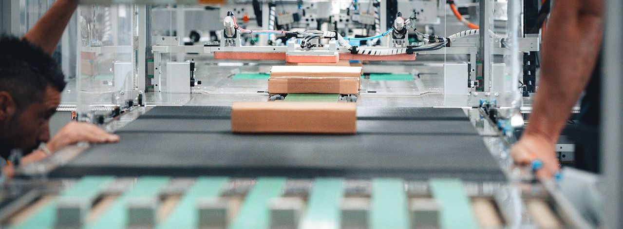Packages moving through a CMC automated packaging line